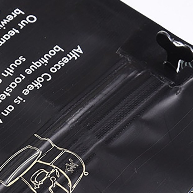Coffee bag zipper and tear notch detail for resealable packaging