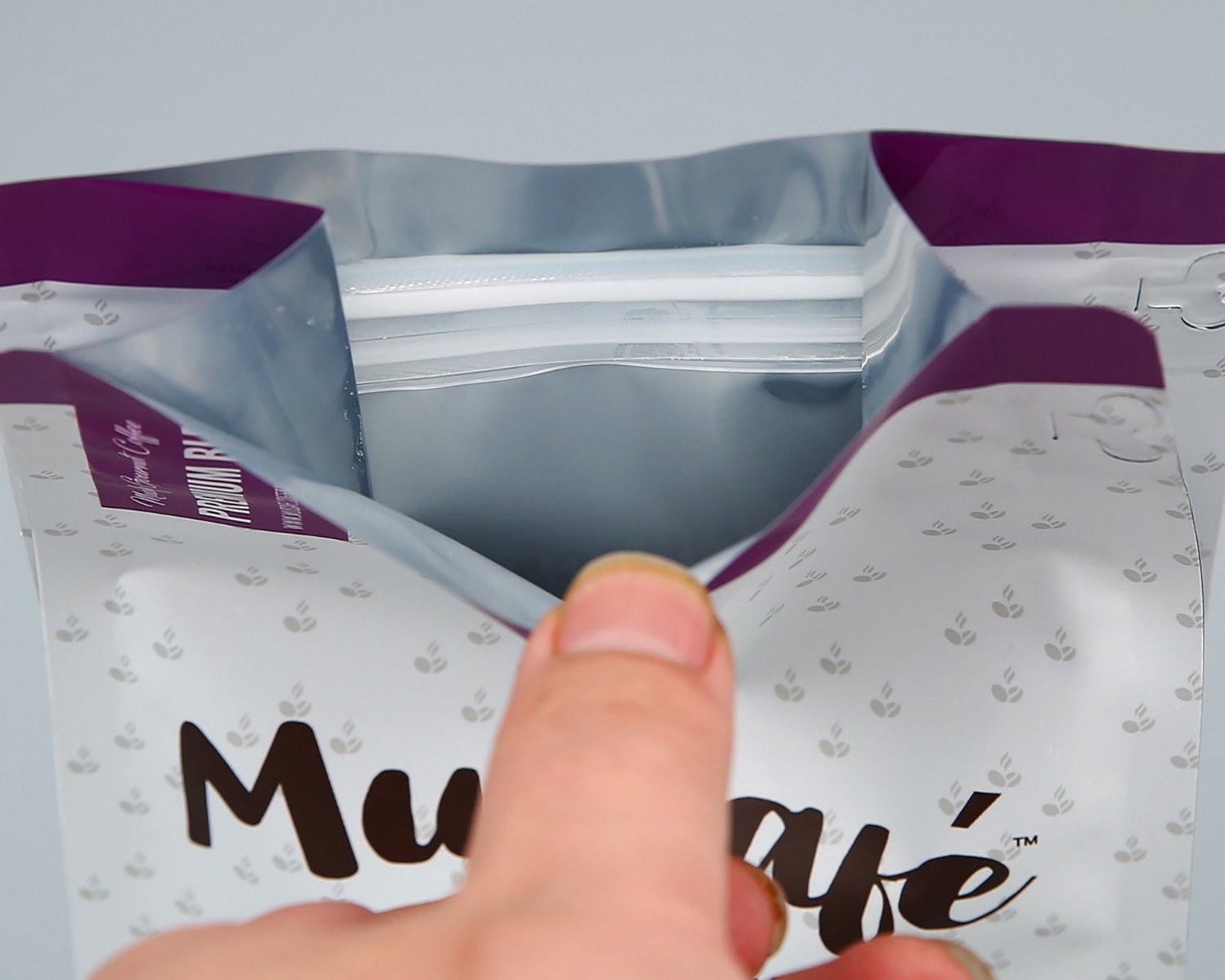 Opened coffee pouch showing a resealable zipper and inner surface